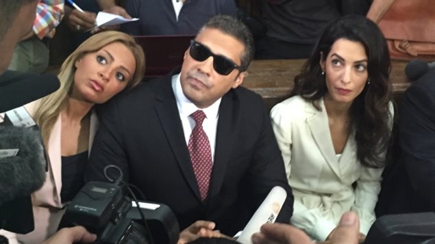 Mohamed Fahmy (centre) in a Cairo court with his wife Marwa (left) and human rights lawyer Amal Clooney, on August 30th as he awaited his retrial verdict. The judge sentenced him and two fellow Al-Jazeera journalists to three years in prison.
