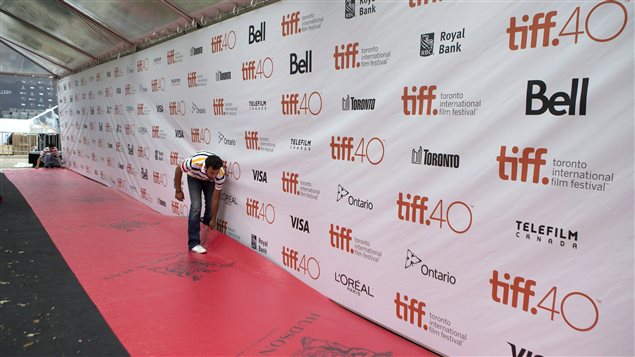 Putting the final touch to a red carpet at Roy Thompson Hall as preparations are made for the opening of the 2015 Toronto International Film Festival in Toronto today