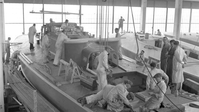 Workers on the deck of a motor torpedo boat, under construction in Montreal, Québec, Canada, 24 April 1941. Canada's role in the war was critical in the victory, providing all types of military hardware along with food, construction material, oil, medicine, clothing and valiant fighting forces.