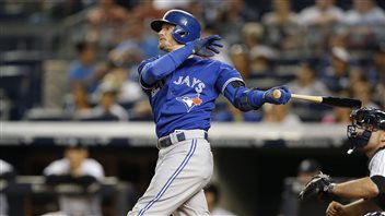 Blue Jays' third baseman Josh Donaldson watches his first-inning, two-run home at Yankee Stadium on Friday. With three weeks left in the regular season, Donaldson is a strong contender for the American League Most Valuable Player. Donaldson, a righty hitter, is in full stride. His left foot is far forward, his bat trails behind him in his left hand. He is all concentration. He has a wispy blond beard and a look of intense concentration on his face under his blue batting helmet and over his blue Jays jersey and grey trousers.