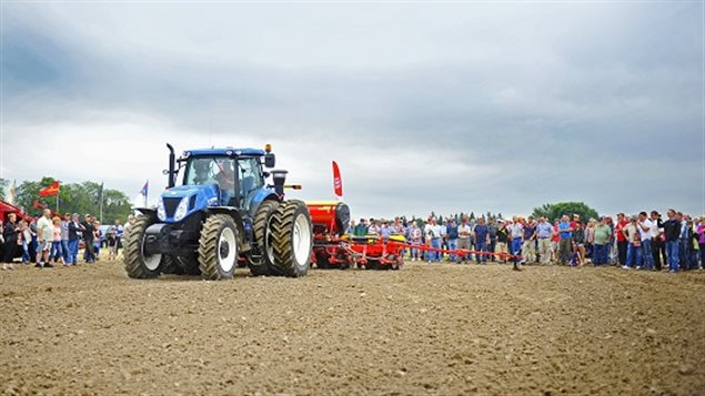 Interested crowds gather to watch a demostration of new seeding quipment and technology at the Outdoor Farm Show in Woodstock Ontario