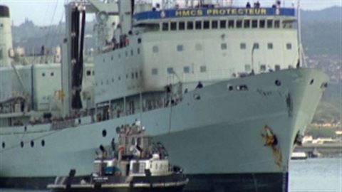 HMCS Protecteur under powerless, entering Pearl Harbour in March of 2014. damage was too extensive to the old ship to merit repair and it has been decommissied