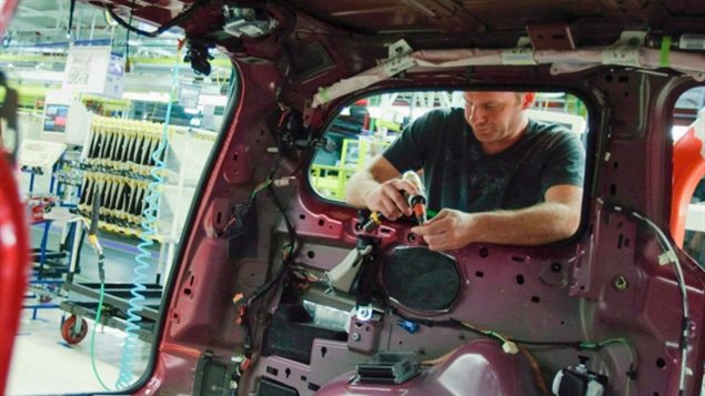 An auto worker assembles a car at a Canadian auto plant. The TPP will reduce Canadian content in cars sold in Canada but the Prime Minister has announced a one billion dollar fund to boost the industry in Canada