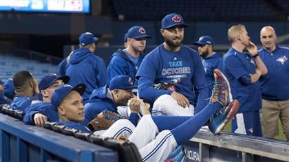 Members of the Blue Jays gather before a team workout at the Rogers Centre in on Tuesday. Can the boys of summer keep it up in the fall? We see the boys dressed in blue sweat shirts with the words 