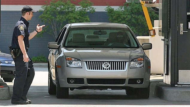 CBSA agent waves a car over for secondary inspection at a US-Canada border crossing. Budget cuts starting in 2012 have meant a dwindling number of agents at entry points and for other inspections, cush aas ship and plane cargo