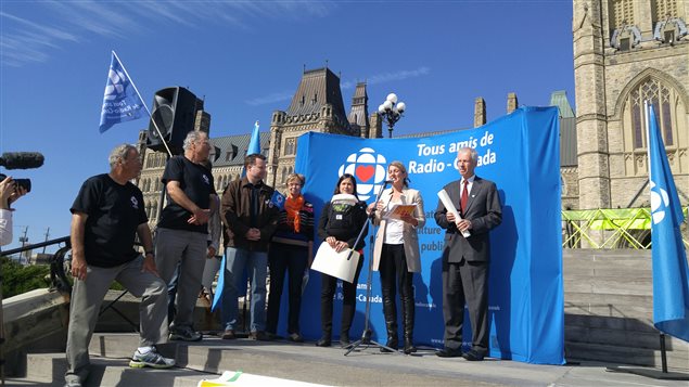 Melanie Jolie a federal Liberal candidate delivers a short speech. Receiving the Tous Amis group's declaration on behalf of the federal Liberal party is Stephane Dion (with suit and red tie), a Member of Parliament and former Liberal leader from 2006-2008