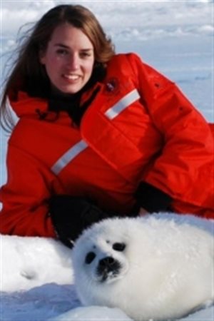 nimal rights path to the Supreme Court of Canada. We see a lovely woman of about 30 tilting slightly to her right as she sits behind a white baby seal, which she is comforting. She wears a bright red parka, has a lovely smile and and open face.