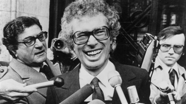 Ken Taylor laughs as he answers questions during a brief meeting with journalists outside the Canadian embassy in Paris on Jan. 31, 1980. 