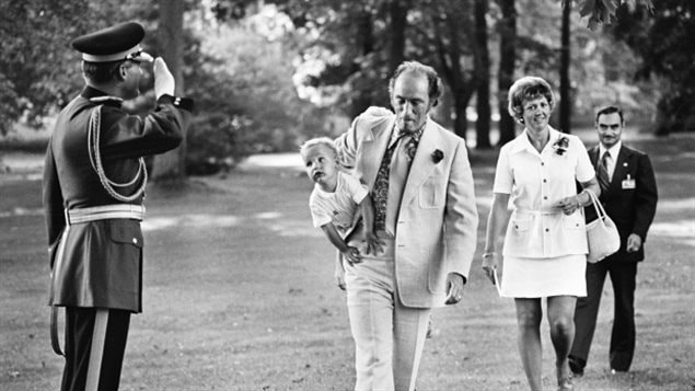 Prime Minister Pierre Trudeau is saluted by a security in 1973 as he carries Justin to an outdoor reception for visiting heads of the Commonwealth countries in Ottawa. As a child, Justin didn't know exactly what his dad did other than that he was the 'boss of Canada.'
