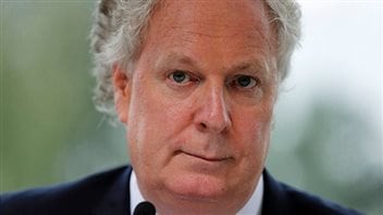 Jean Charest says he's perfectly happy to make his living as a lawyer at a prominent Montreal law firm and won't be returning to politics. We see a very tight closeup of Charest's face. The photo is cropped at the top of his forehead but his hair does appear slightly whiter than in the photo at the top. Her wears a slightly chagrined expression.