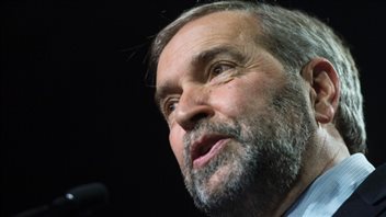 Most analysts agree that Mulcair's niqab stand cost him seats in Quebec. We have a shot looking up at the left side of Muclair's bearded face. His mouth is slightly open as he appears to be speaking. His grey hair is nicely combed.