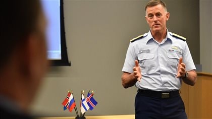 U.S. Coast Guard Commandant Adm. Paul Zukunft speaks during the Arctic Coast Guard Forum, at U.S. Coast Guard Headquarters in Washington, March 25, 2015. In the photo we see a man in coast guard uniform addressing an audience, standing next to a table with small flags of participating nations.