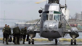 Canadian soldiers board a Sea King helicopter as they participate in advanced amphibious training from the Shearwater Jetty in Halifax on Tuesday, July 30, 2013.