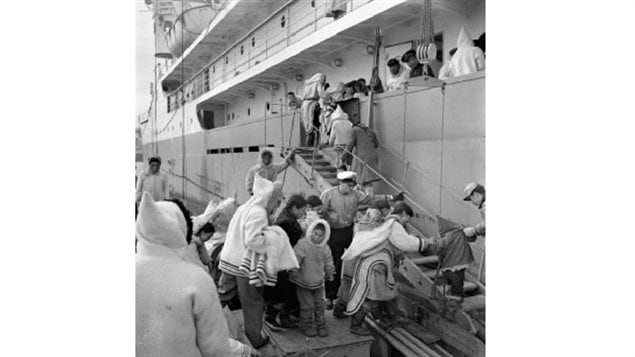 Inuit board the C.D. Howe for medical and eye check-ups Kimmirut (formerly Lake Harbour), Nunavut, 1951. Throughout the 1950s and 60s the ship made summer medical trips to the Eastern Arctic. If TB was found, the individual was kept on baord and not allowed to go ashore to collect belongings or say goodbye, before sailing south for treatment which could take 2-3 years. Some never returned, In 1956, one seventh of entire Inuit population was being treated in southern Canada.