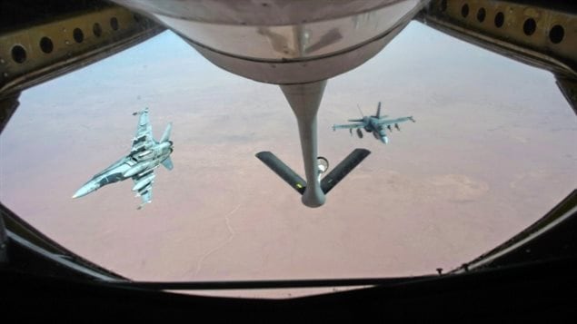  Royal Canadian Air Force CF-18 Hornet breaks away after refueling with a KC-135 Stratotanker over Iraq. (HO-U.S. Air Force Photo by Staff Sgt. Perry Aston/Canadian Press)