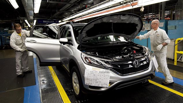  Workers inspect vehicles and work on the assembly line at Honda of Canada Mfg. Plant 2 in Alliston, Ont., on Monday, March 30, 2015. THE CANADIAN PRESS/Nathan Denette