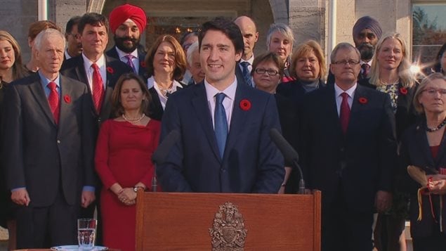  Prime Minister Justin Trudeau speaks in front of his cabinet outside Rideau Hall after a swearing-in ceremony Wednesday, Nov. 4, 2015.