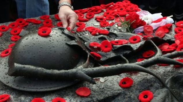People have created a spontaneous tradition of placing their poppies on the Tomb of the Unknown soldier at the base of the National War Memorial following Remembrance ceremonies in Ottawa, the national capital.