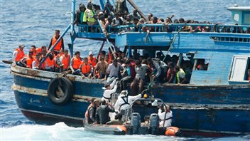 Refugees were taken off wooden boats and ferried by dinghy to the Phoenix, a rescue ship run by MSF.