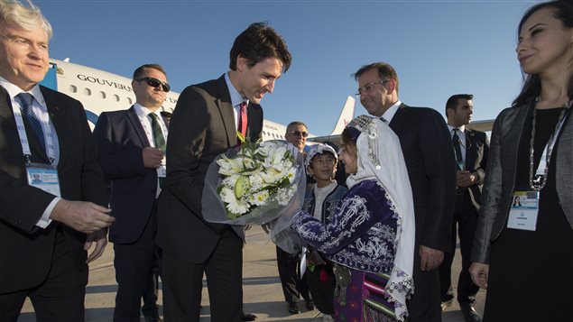  Prime Minister Justin Trudeau is presented with flowers as he arrives in Antalya, Turkey on Saturday, November 14, 2015, to take part in the G20 Summit. 