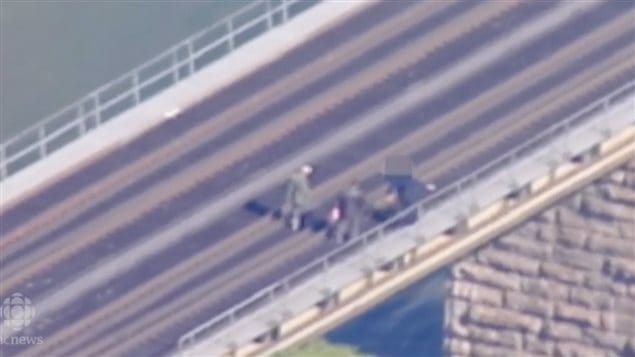 Surveillance footage of two men on a railway bridge. Raed Jaser and Chiheb Esseghaier were found guilty on eight terror related charges after they planned to plant bombs to derail a passenger train on the bridge in Ontario. Cooperation between intelligence services enabled authorities to foil the plot.