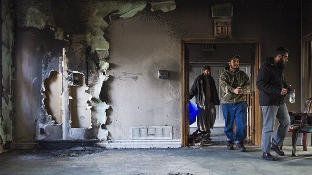  Congregation members clean up debris, on Sunday, November 15, 2015, after the only mosque in Peterborough, Ont., was deliberately set alight Saturday night.