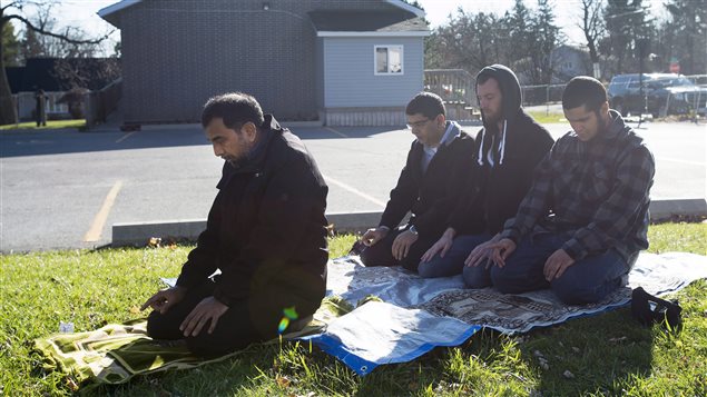  A group of men pray outside of the mosque Masjid Al-Salaam in Peterborough, Ont., on Monday, November, 16, 2014. 