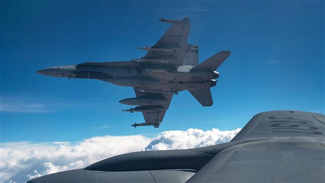  A Royal Canadian Air Force CF-18 Hornet breaks away after refueling with a KC-135 Stratotanker assigned to the 340th Expeditionary Air Refueling Squadron, Thursday, Oct. 30, 2014 over Iraq. 