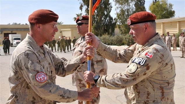  Comd Multinational Force and Observers Maj.-Gen. Denis Thompson (L) installs the new Commander of the Force’s Military Police.