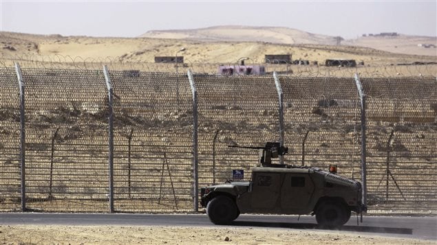  An armoured Israeli military vehicle drives along Israel's border with Egypt's Sinai peninsula, near the Nitzana crossing in this picture taken January 30, 2014. 