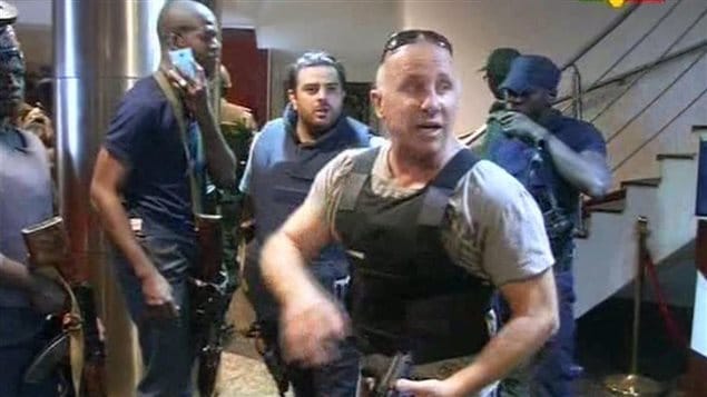  In this TV image taken from Mali TV ORTM, a security officer gives instructions to other security forces inside the Radisson Blu Hotel in Bamako, Mali, Friday Nov. 20, 2015. 