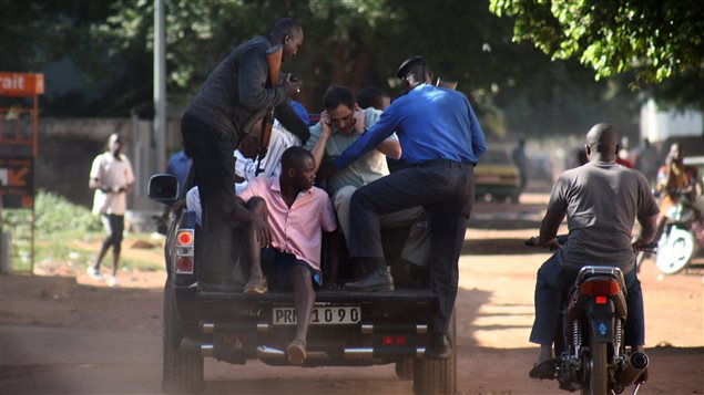  Des militaires maliens évacuent des otages de l'hôtel Radisson de Bamako.