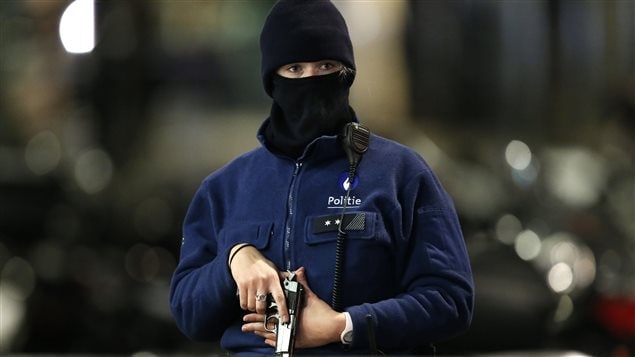  A Belgian police officer searches the area during a continued high level of security following the recent deadly Paris attacks, in Brussels, Belgium, November 22, 2015.