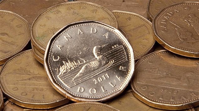 Falling oil prices pushed the Canadian dollar Monday to its lowest level compared with the U.S. dollar since June 2004.