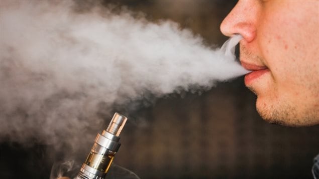 A man smokes an electronic cigarette vaporizer, also known as an e-cigarette.  Those "vaping" marijuana will be exempt from limitations on where one can otherwise use e-cigarettes in Ontario
