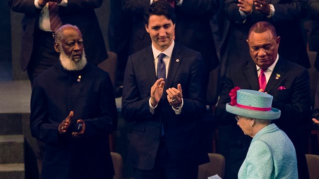 Canada's recently elected Liberal Prime Minister Justin Trudeau (centre) applauds Her Majesty Queen Elizabeth II at the Commonwealth leaders meeting in Malta. He later announced a doubling of Canada's contribution to a climate change fund