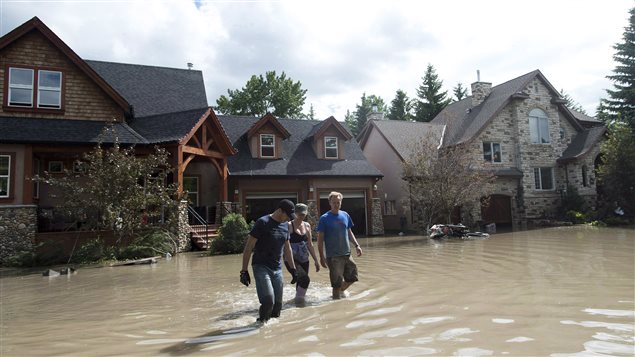 Residents waded through flood waters in the western city of Calgary on June 24, 2013. The government of the province of Alberta called the flood its worst natural disaster and pegged the cost at $6-billion.