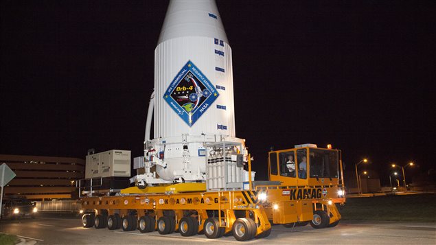  A transporter moves Orbital ATK's enhanced Cygnus spacecraft, fitted inside the payload fairing of a United Launch Alliance Atlas V, from the Payload Hazardous Servicing Facility at NASA's Kennedy Space Center in Florida to Space Launch Complex 41. The Cygnus is a cargo-only spacecraft that will take about 7,300 pounds of experiments, equipment and supplies to the International Space Station.