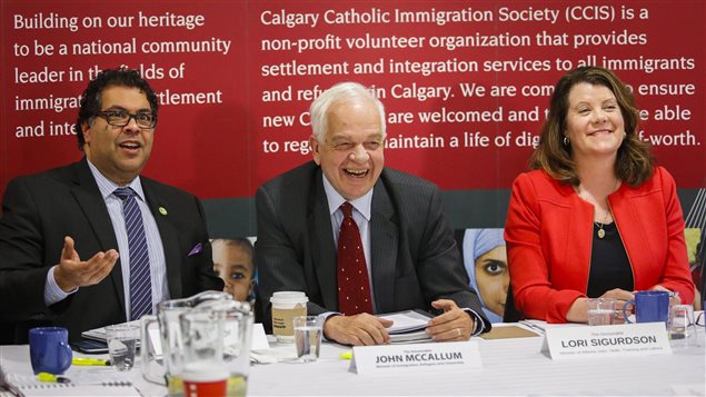  John McCallum, centre, Minister of Immigration, Refugees and Citizenship, meets with Calgary Mayor Naheed Nenshi, left, and Lori Sigurdson, Alberta Minister of Advanced Education and Minister of Jobs, at the Margaret Chisholm Resettlement Centre in Calgary, Alta., Wednesday, Dec. 2, 2015.