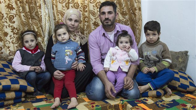  Syrian Refugee Samer Albqerat from Tal Shehab, Syria sits with his wife Doaa and daughters Nada, 6, Braa, 3, Goly, 9 months, and son Khald, 5, left to right, in Tuesday, December 1, 2015 in Irbid, Jordan. The family is waiting for approval to immigrate to Canada.