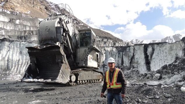 Huge excavators needed to remove advancing ice which constantly threatens mine. Global warming is increasing the speed of the glacier and filling the lake above the site.