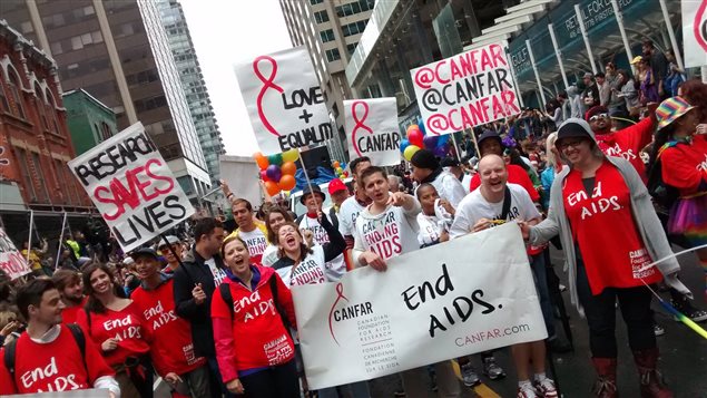 Volunteers raise awareness that AIDS isn’t over at Toronto’s 2015 Pride Parade.