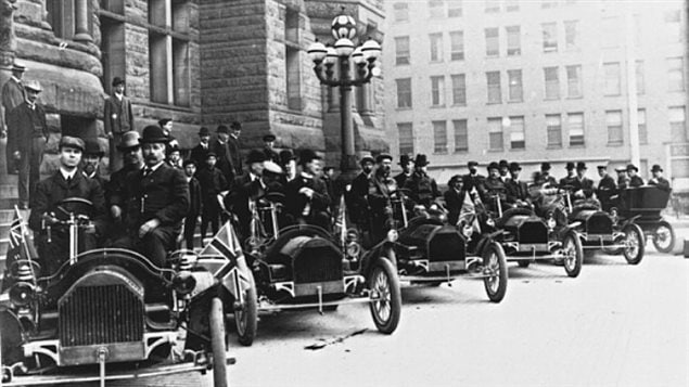 A row of Russell motor cars in front of Toronto city hall in 1909. Tommy Russell is seated in the driver's seat of the first car.