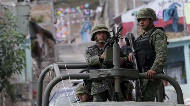  Soldiers atop a vehicle stand guard in the village of Carrizalillo, Mexico, November 12, 2015. Picture taken November 12, 2015.