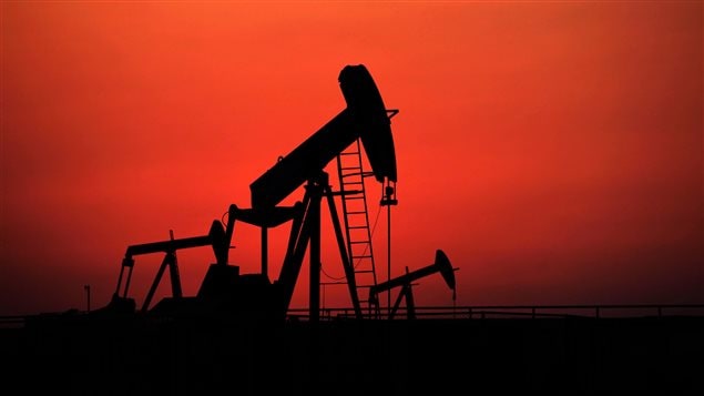 Oil pumps work at sunset on Sept. 11, 2013, in the desert oil fields of Sakhir, Bahrain.