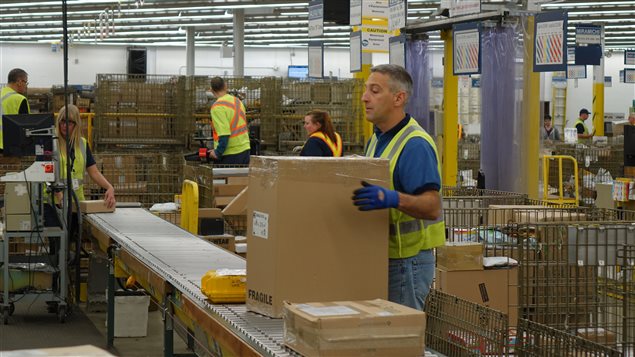 Des employés de Postes Canada travaillent au centre de distribution de Dieppe, au Nouveau-Brunswick.