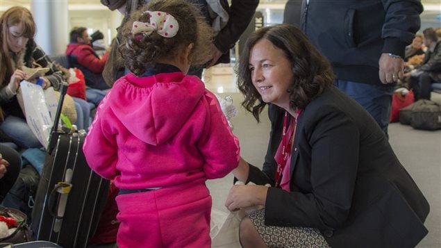  Canada's ambassador to Lebanon, Michelle Cameron, offers a teddy bear to a Syrian child at the beginning of an airlift of Syrian refugees to Canada, at the Beirut International airport December 10, 2015 in a photo provided by the Canadian military. 