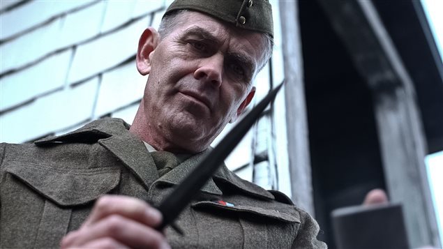 Camp-X documentary scene re-creation of William Fairbarn, a tough instructor at Camp-X in the art of silent killling , holding the Fairbairn-Sykes fighting knife which was adopted by the British Commandos, SAS, and many other elite military and other units