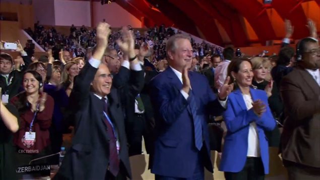 As French President Laurent Fabius declared the document accepted, the huge hall erupted in cheers and applause