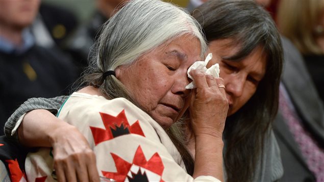  Residential school survivor Lorna Standingready is comforted by a fellow survivor in the audience during the closing ceremony of the Indian Residential Schools Truth and Reconciliation Commission, at Rideau Hall in Ottawa on Wednesday, June 3, 2015. 